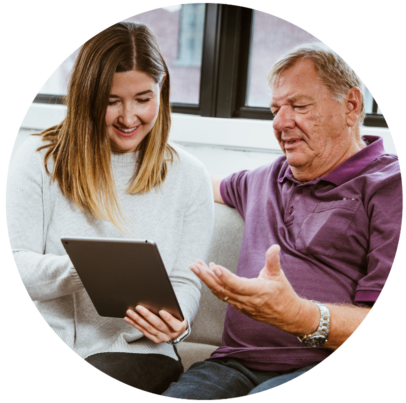 Photo showing that the daughter is helping her father using a tablet device